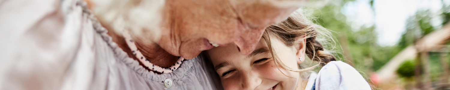 Grandma sharing a moment, hugging her granddaughter.